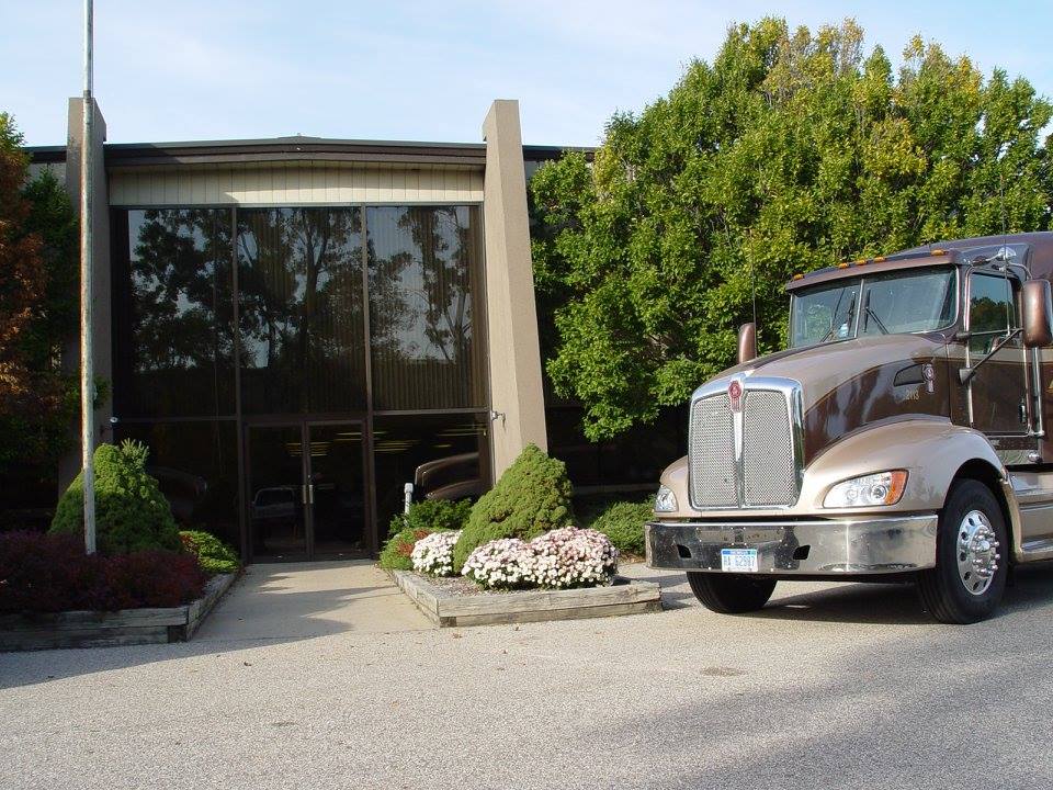 680f80edf0ad5_KWOFFICE A large truck parked in front of a building.