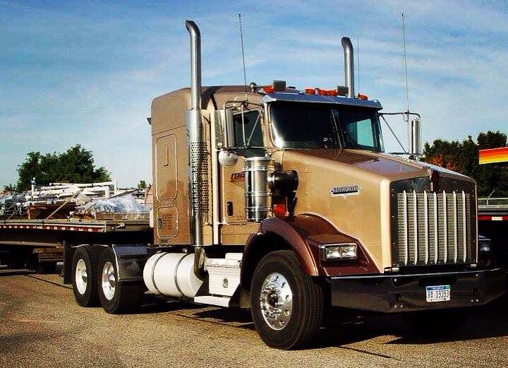A semi truck parked on the side of a road.